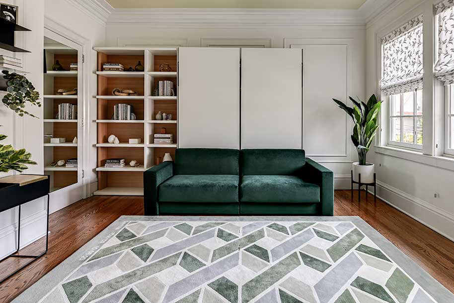 Two single wall beds pushed together to make one queen wall bed with sofa attached