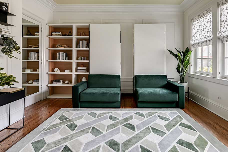 Two single wall beds with sofa seats attached to front