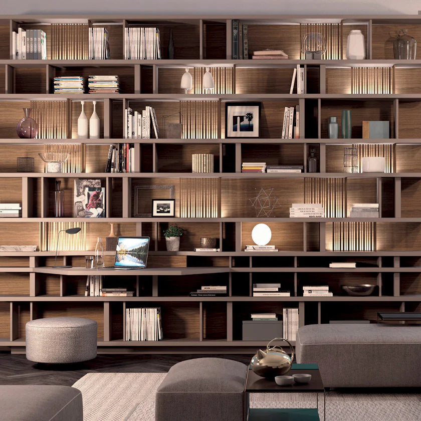 Custom floor to ceiling storage unit with backlit niches and metal grilles
