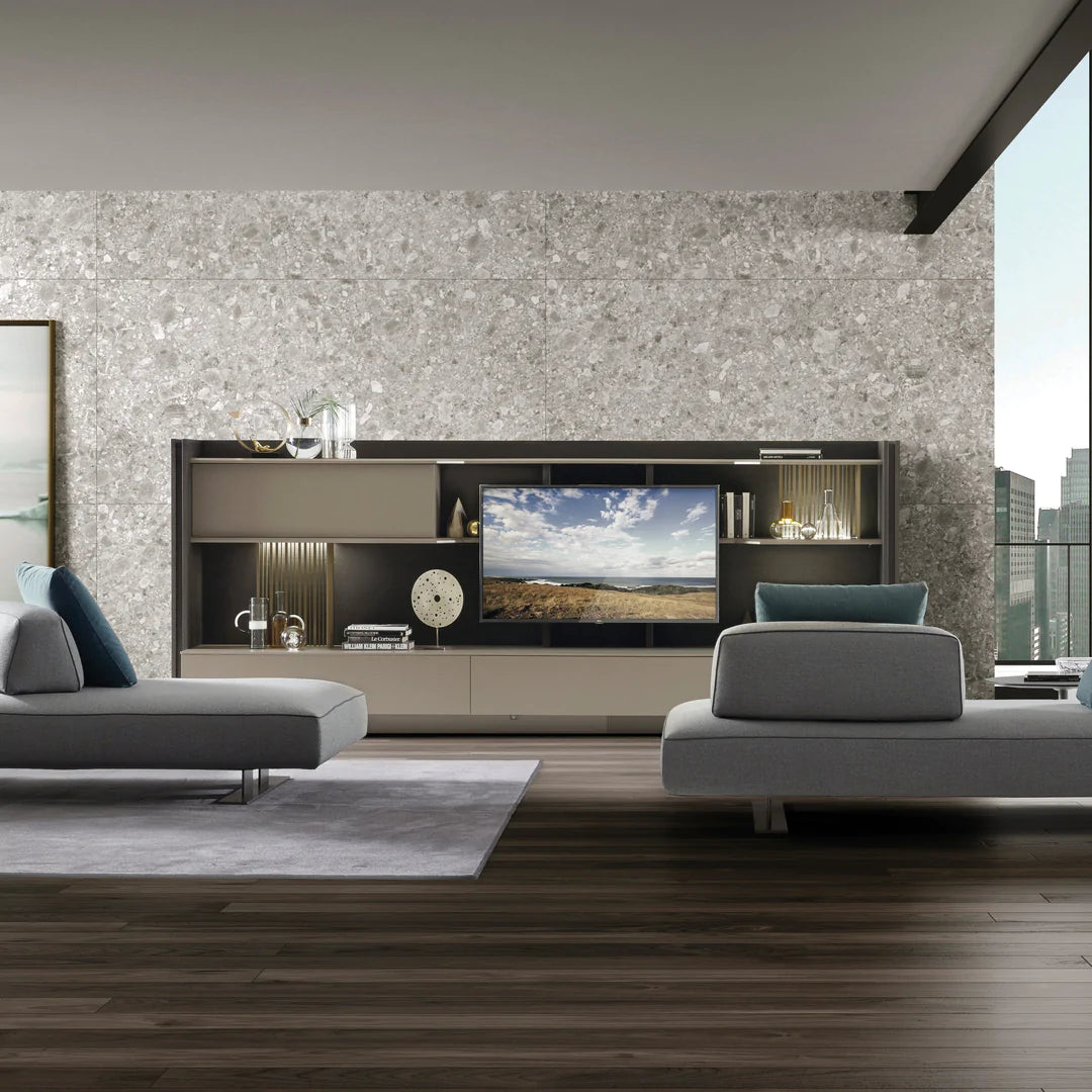 Freestanding media unit with TV and shelving, against living room wall.