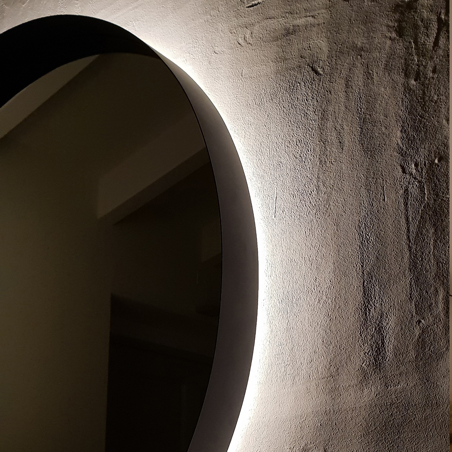 Black circular wall mirror with white LED backlight.