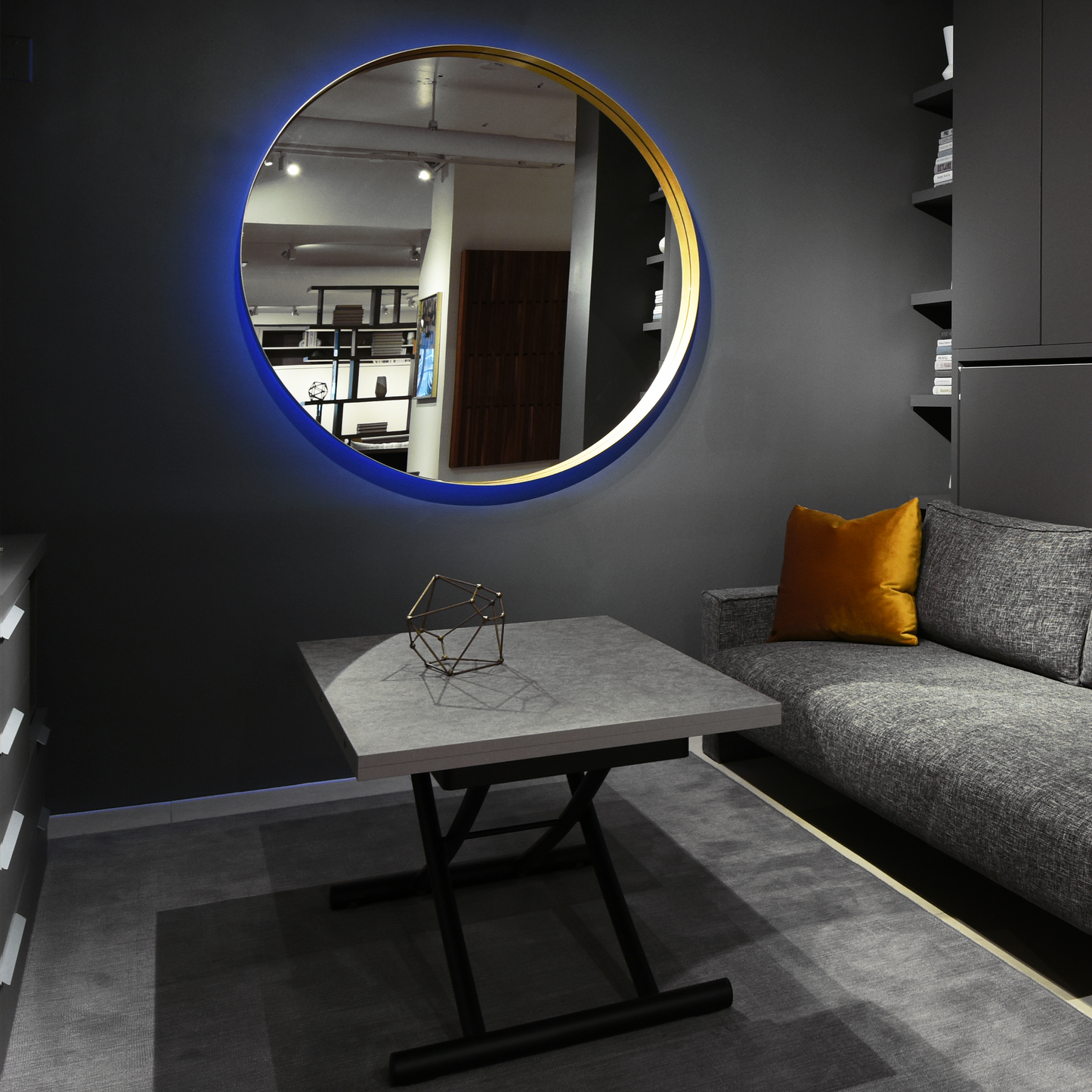 Gold circular wall mirror with coloured LED backlight.