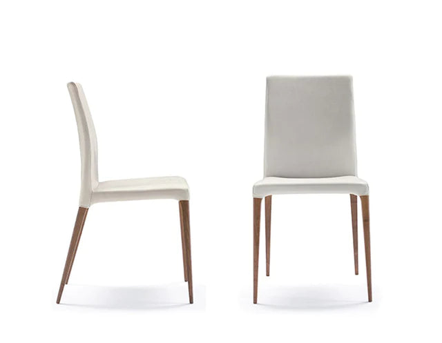 Front and side view of leather dining chair with wooden legs.