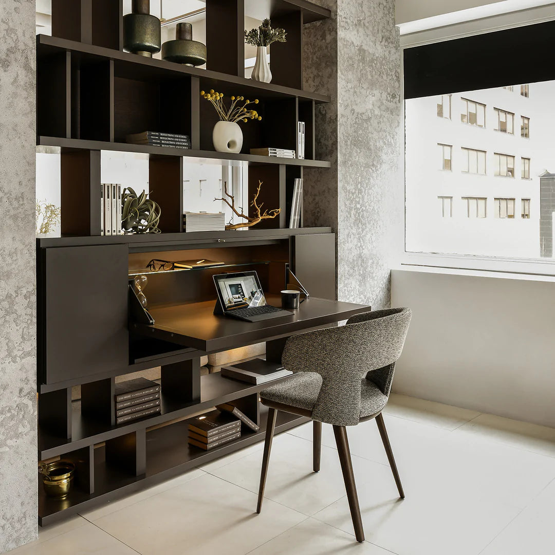 Shelving unit between two walls, with fold out desk open.