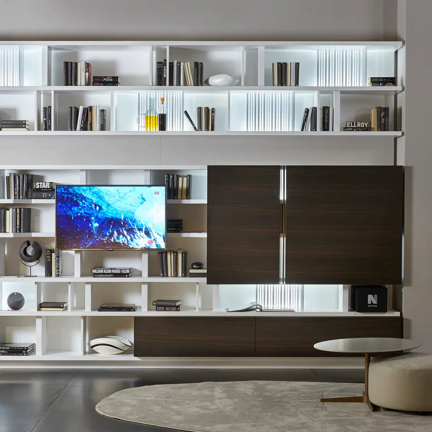 Wall to wall custom shelving unit with dividers and TV panel.