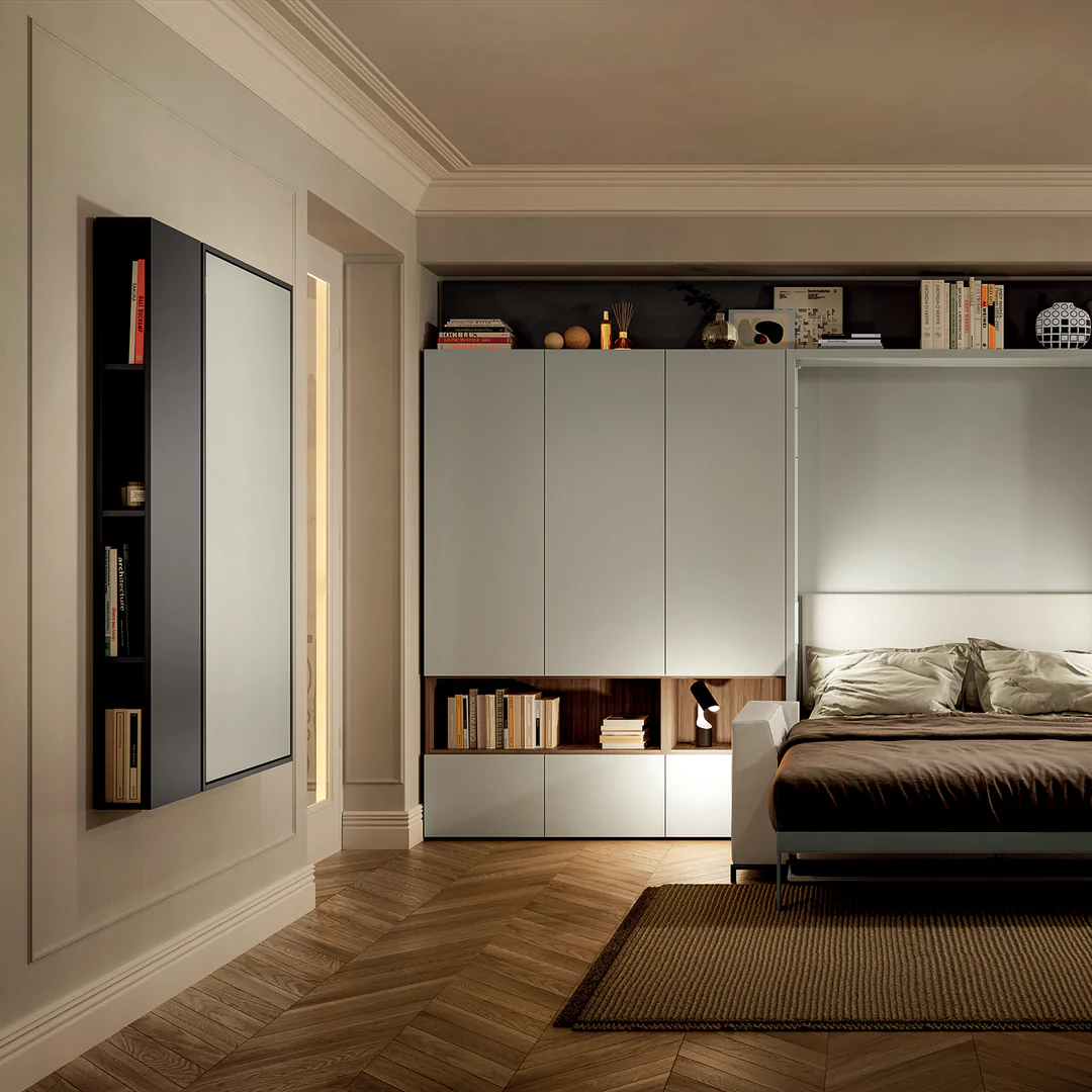 Wally desk unit closed in living area. Wall mounted structure sits flush against the wall. Wall bed is open.