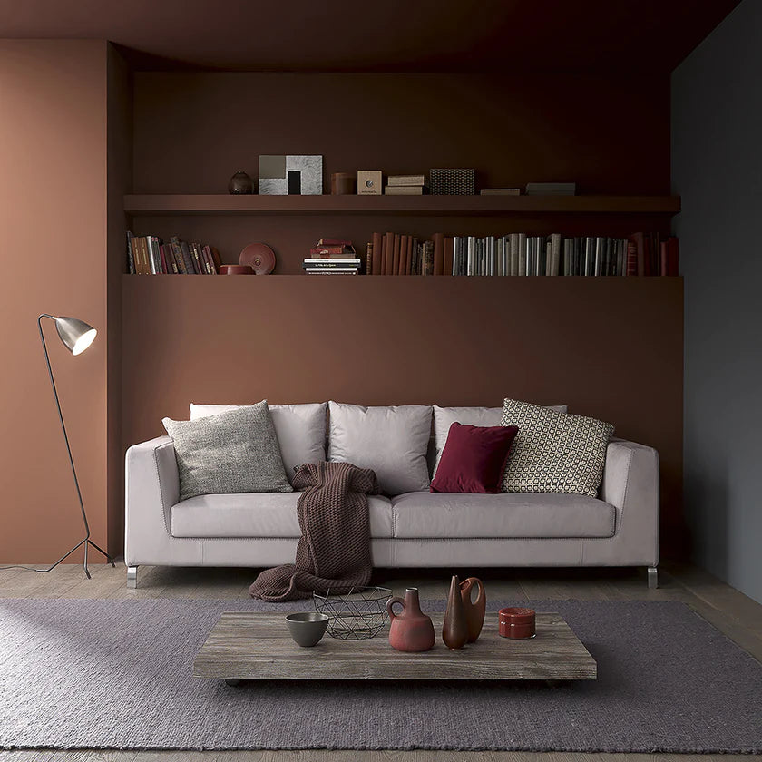 Genie transforming table at coffee table height in front of sofa.