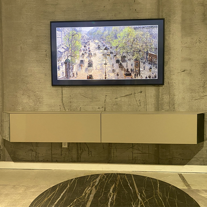 Two wall mounted storage containers beneath a TV