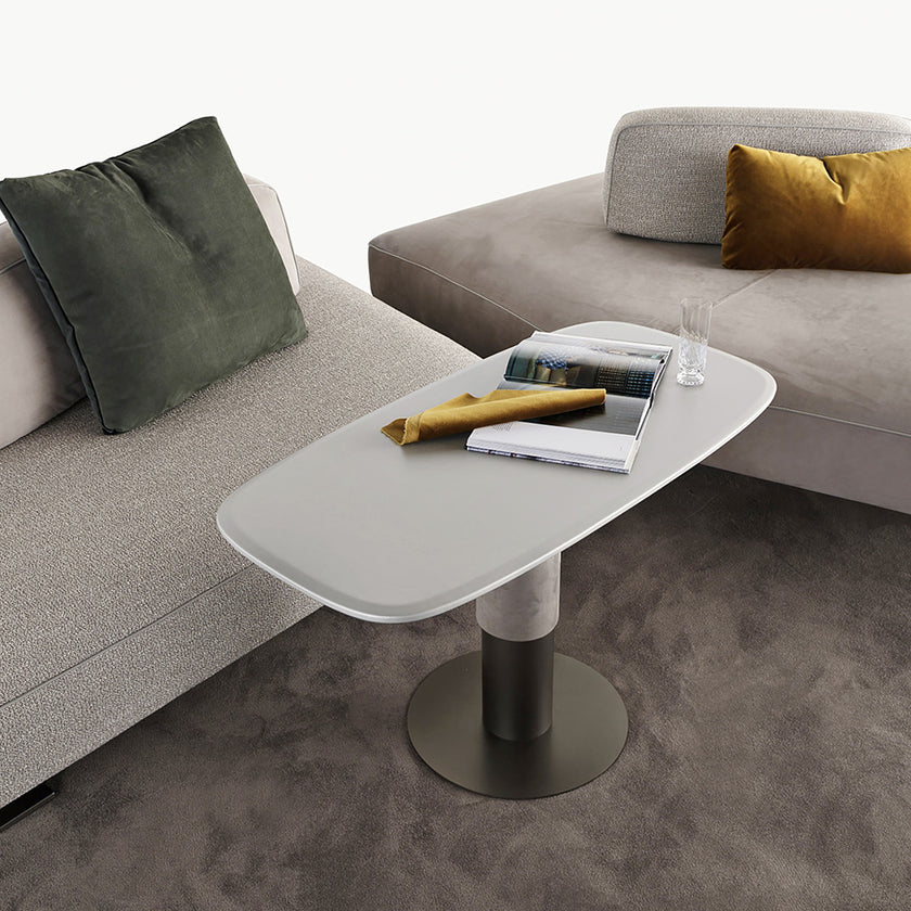 Dynamic lift table set between two sofas.