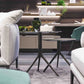 Side tables in two different heights with dark marble top and grey flared base,