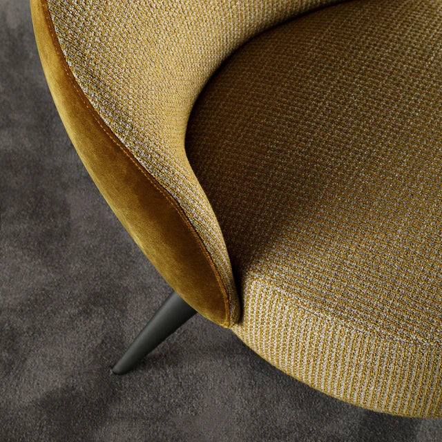 Close up of dual upholstery on low profile armchair.