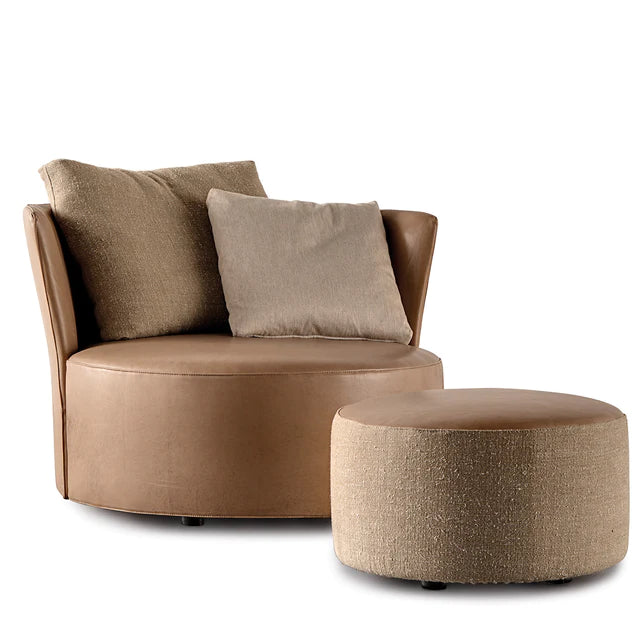 Leather 'cuddle' armchair with ottoman.