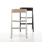 Folding dining chairs in black wood and light wood.