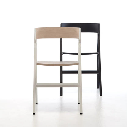 Folding dining chairs in black wood and light wood.