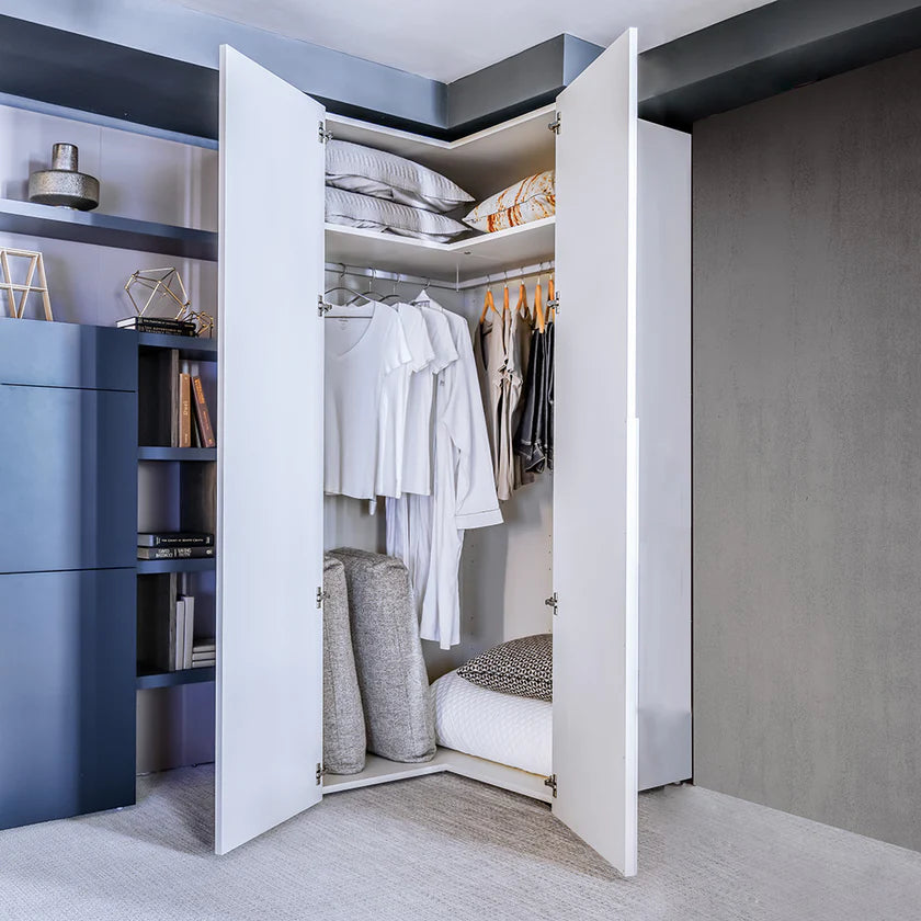 L shaped corner closet open to reveal hanging bars and storage.