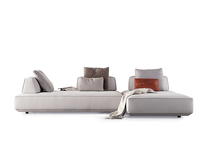 Modular sofa with cushions and blankets.