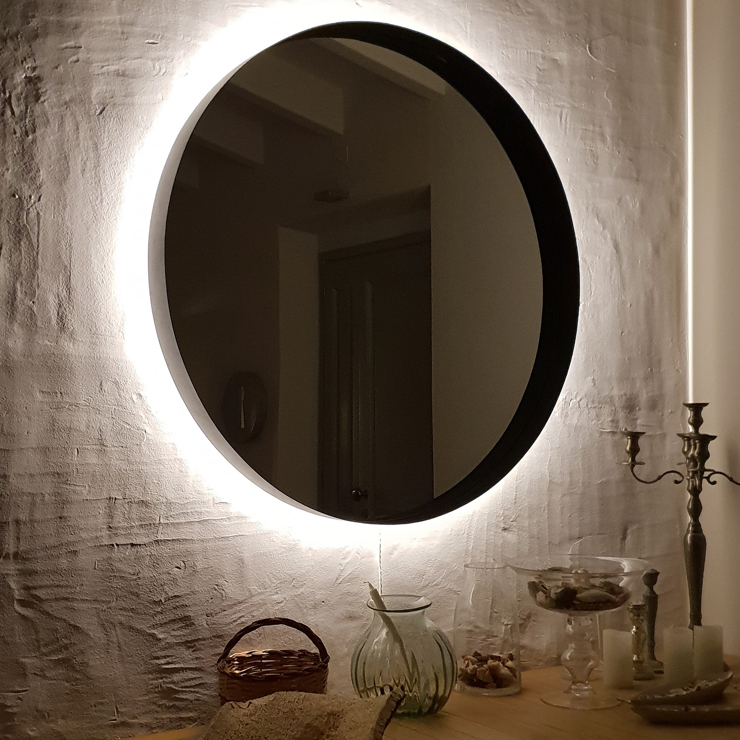 Large circular wall mirror with white backlight.