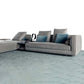 Modular sofa with cushions and blankets, white background.