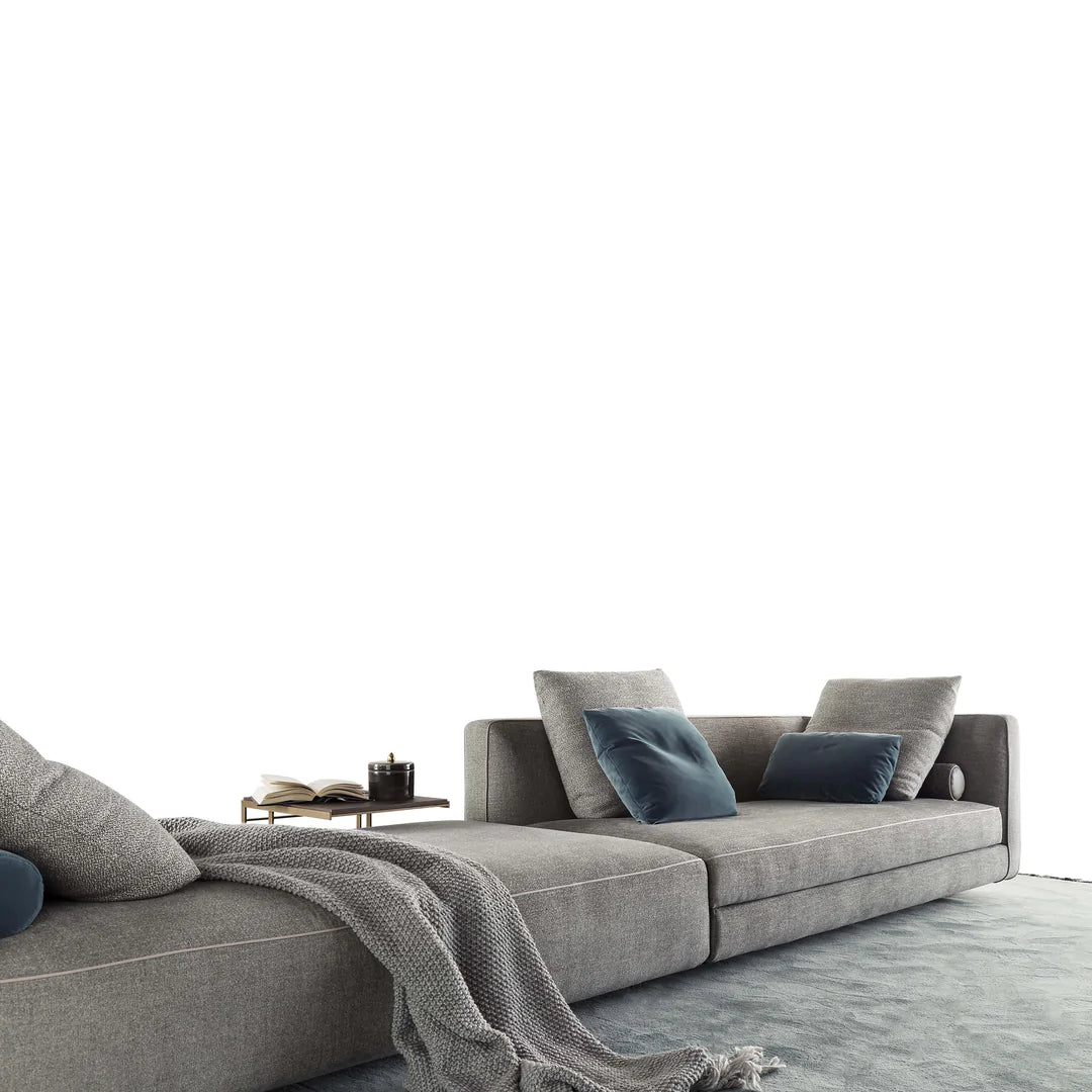 Modular sofa with cushions and blankets, white background.
