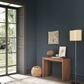 Wooden console table flush against wall.