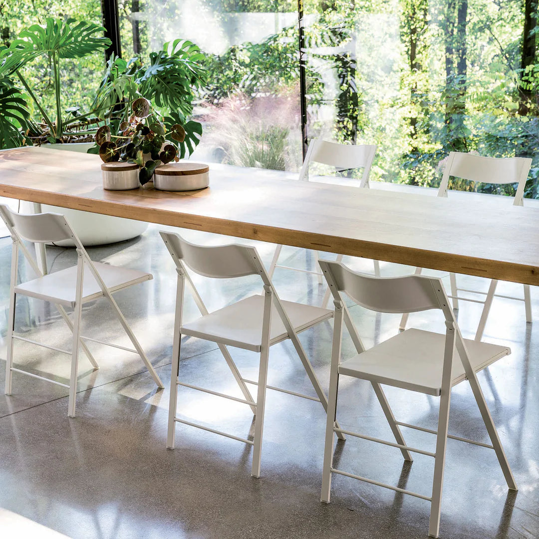 Folding chairs set around a dining table.