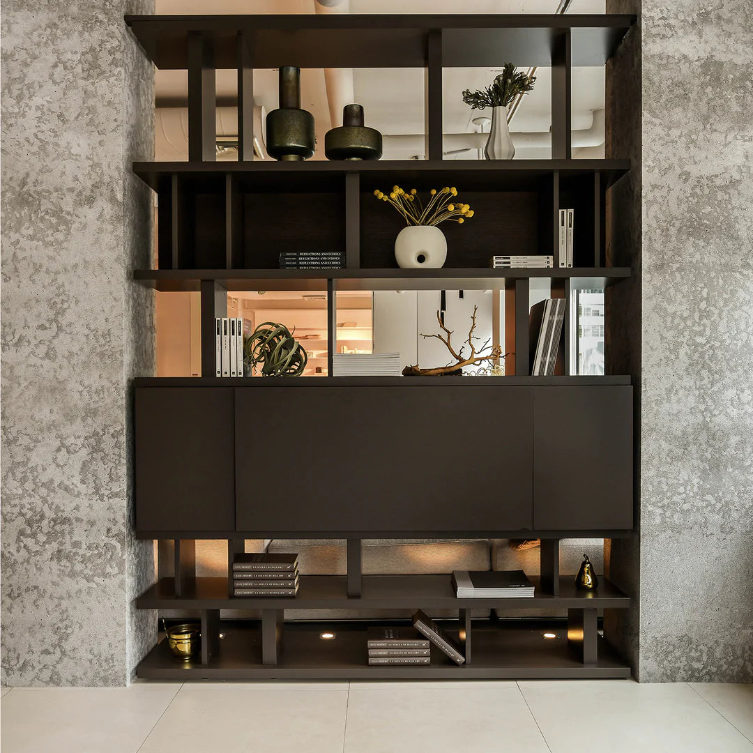 Shelving unit between two walls, acting as a room divider.