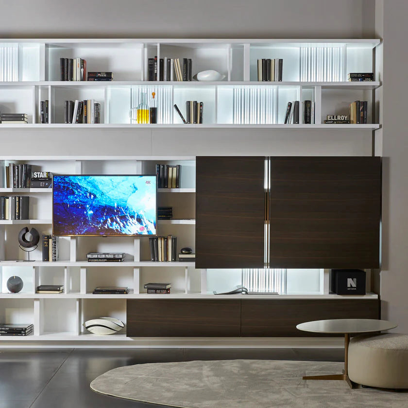 Wall to wall custom shelving unit with dividers and TV panel. 