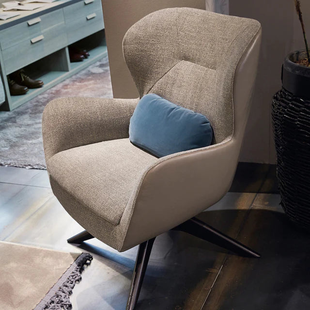 Cosy armchair with swivel base and upholstered seat.