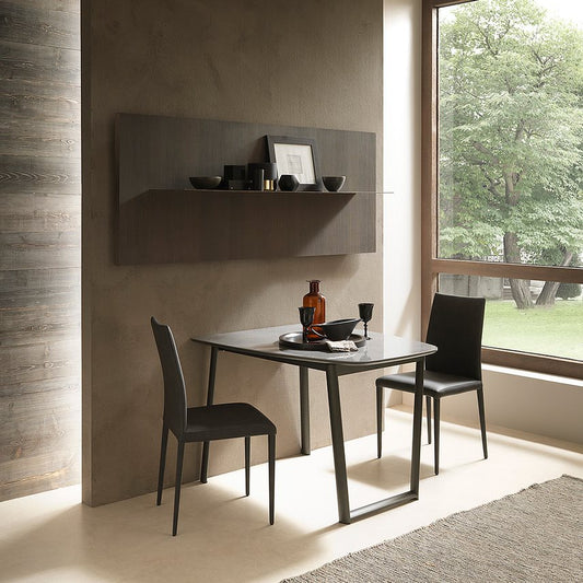 Dining table against wall set up for two people.