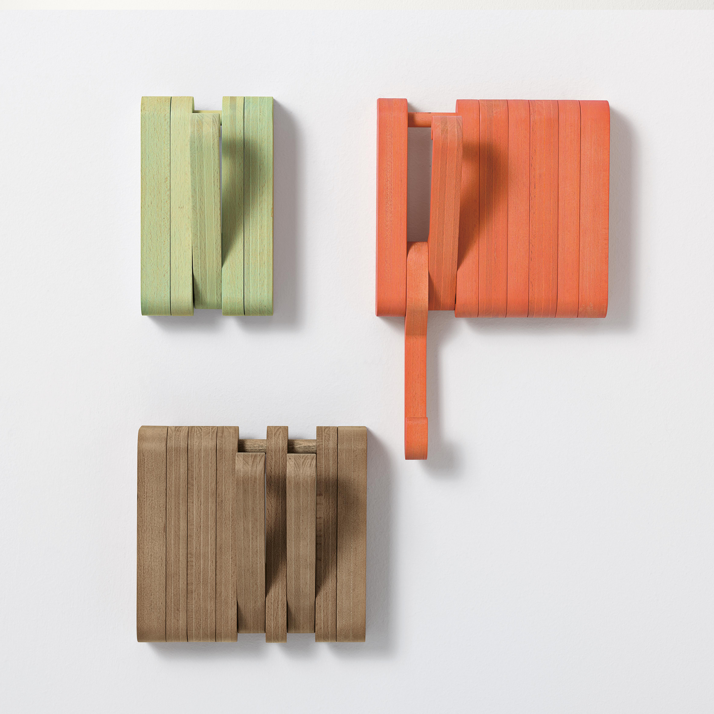 Wooden wall hooks open and closed.