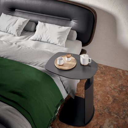 Zoom table being used as a bed side table with coffee cups on top.